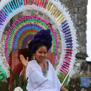 The Huipil Queen of Cuetzalan, radiant in her ceremonial attire, greets festival guests with grace and pride, embodying the spirit of the Huipil and Coffee Celebration.