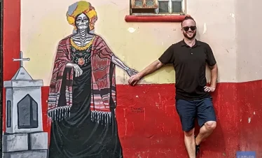 Traveler holding hands with a Catrina figure during Day of the Dead ,in Mexico
