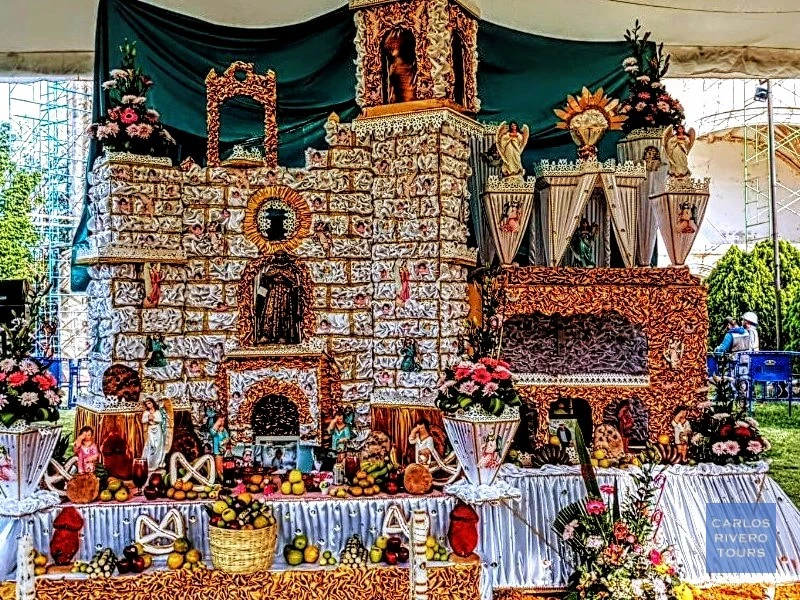 Day of the Dead altar in Huaquechula honoring local artist Nachito – traditional multi-tier tribute with candles, flowers, and personal memorabilia.