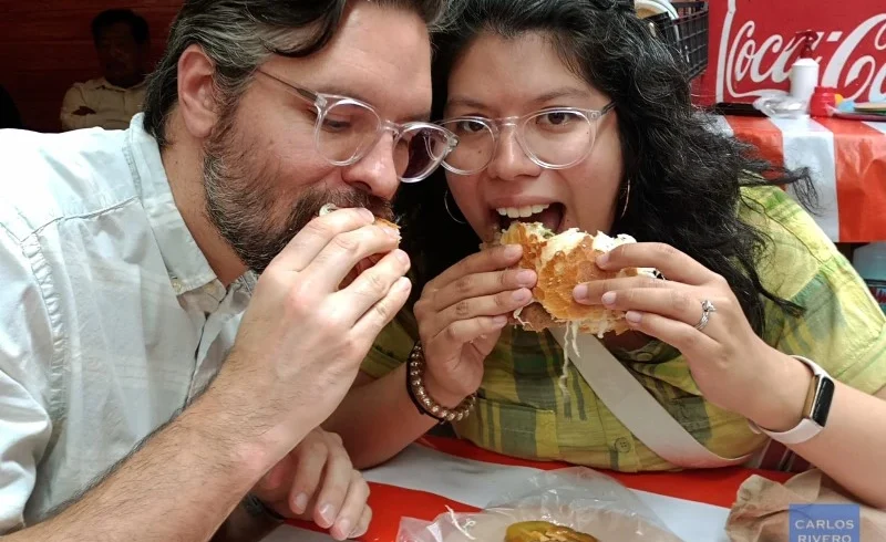 Couple enjoying one of Puebla’s most iconic street food specialties during a walking tour in the historic center, savoring traditional flavors and local atmosphere.