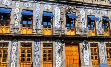 Historic house in downtown Puebla adorned with traditional Talavera ceramic tiles, showcasing colonial architecture and regional craftsmanship.