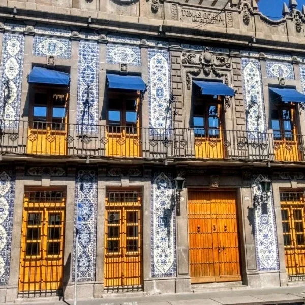 Historic house in downtown Puebla adorned with traditional Talavera ceramic tiles, showcasing colonial architecture and regional craftsmanship.