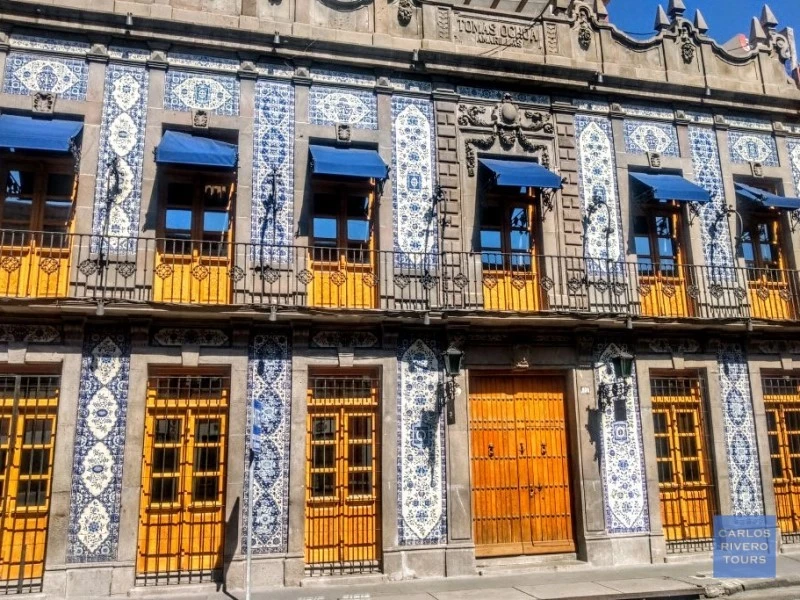 Historic house in downtown Puebla adorned with traditional Talavera ceramic tiles, showcasing colonial architecture and regional craftsmanship.