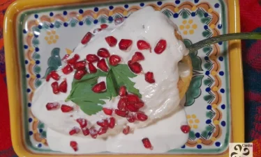 Chiles en Nogada plated on traditional Talavera ceramic from Puebla – showcasing Mexican culinary heritage with iconic dish and artisanal craftsmanship.