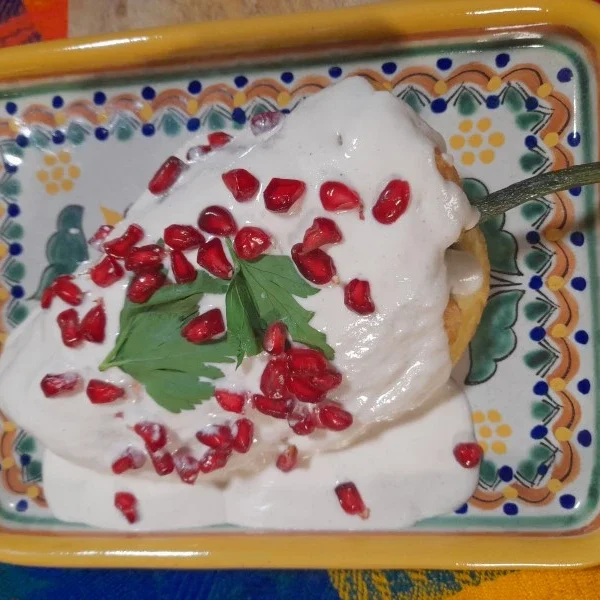 Chiles en Nogada plated on traditional Talavera ceramic from Puebla – showcasing Mexican culinary heritage with iconic dish and artisanal craftsmanship.